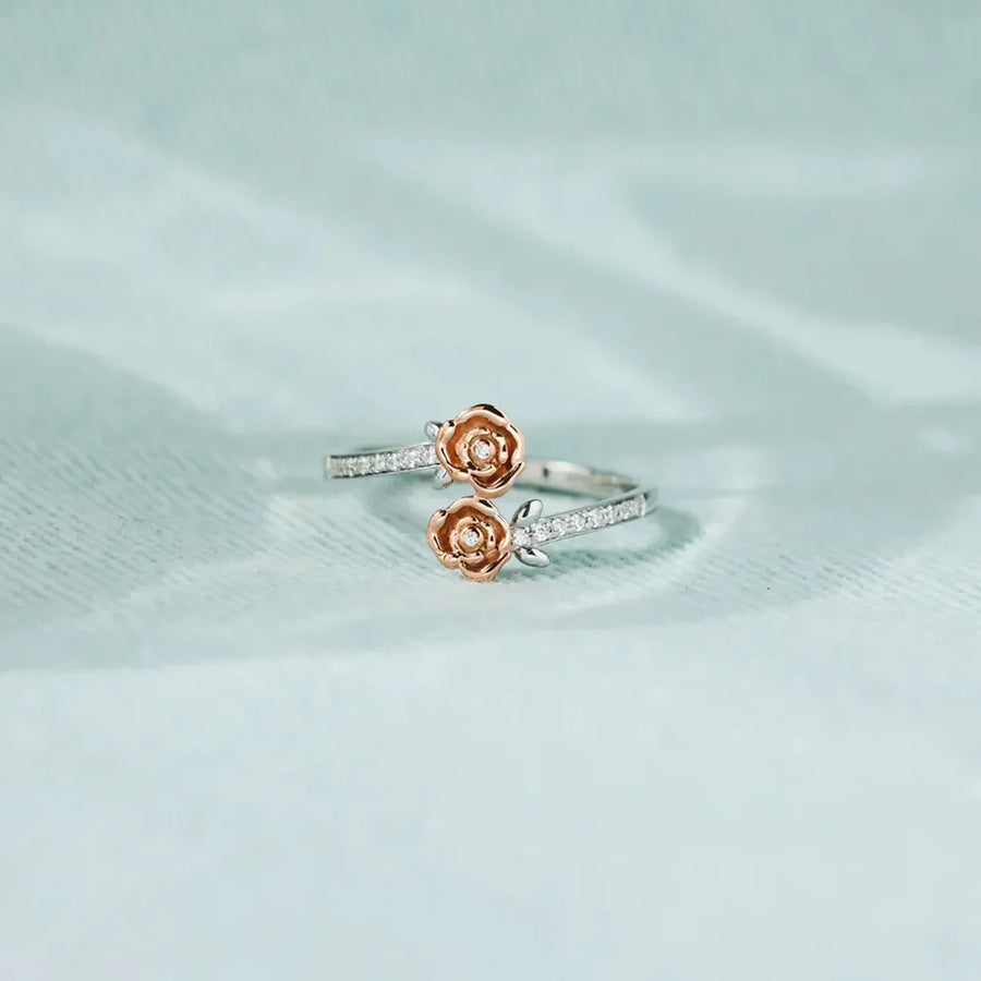 Rosebud bypass ring in silver with pavé detail and two rosebud charms.