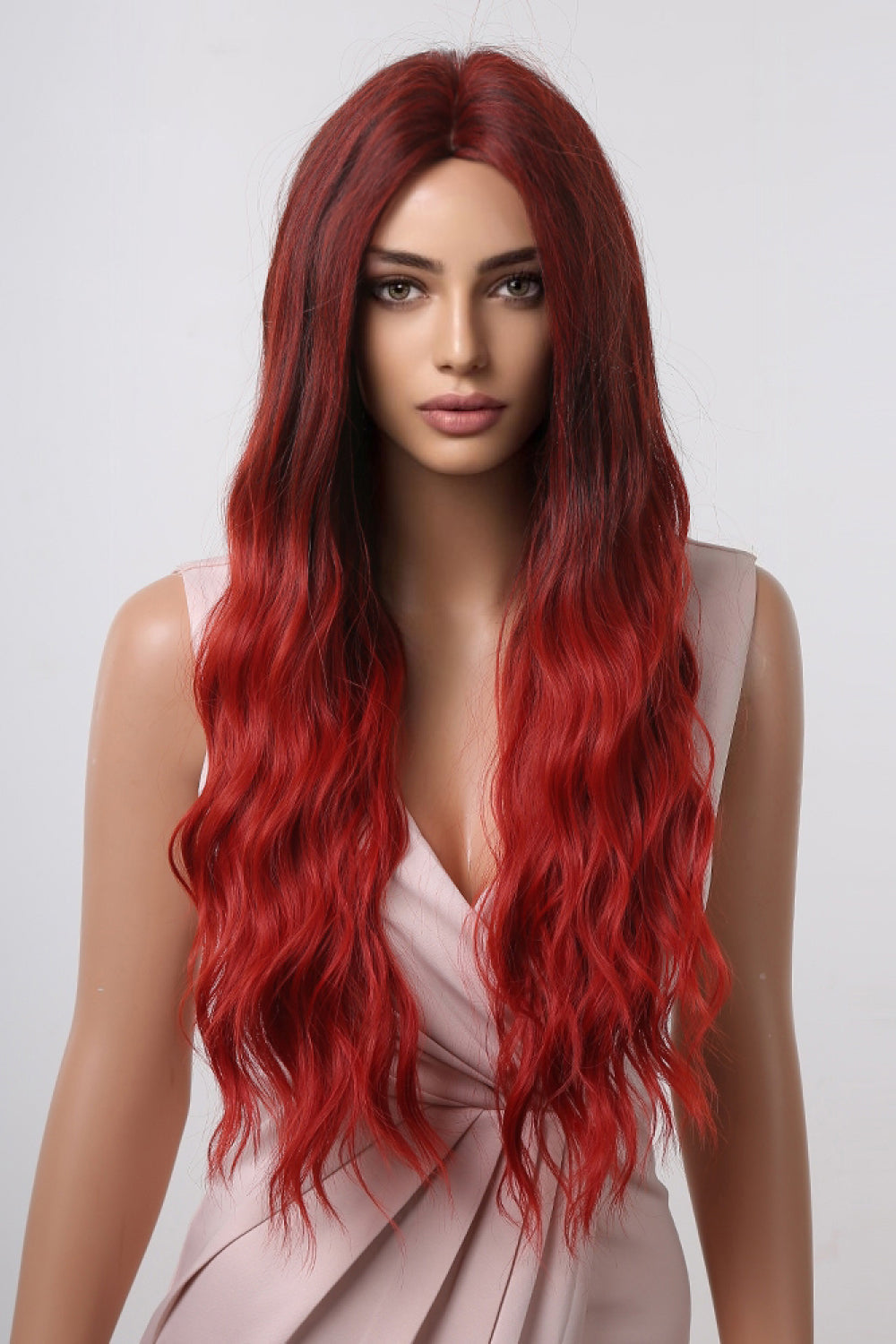 Crimson ombre synthetic wave wig with dark roots and vibrant red ends.