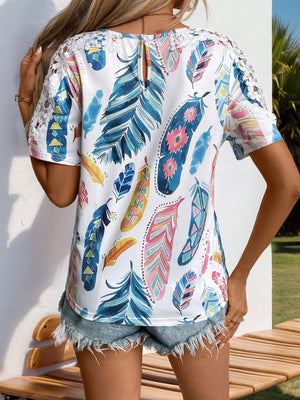 White feather print blouse with crochet sleeves and a keyhole back detail.