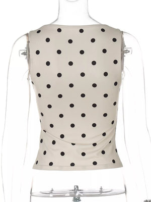 Chic ruffled polka dot tank top in khaki with black dots. Cropped, sleeveless design.