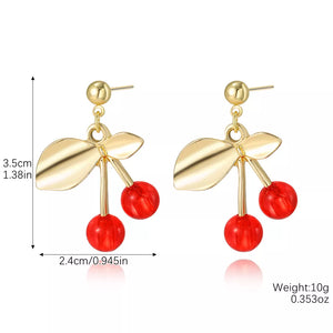 gold earrings featuring dangle design and fruit motif