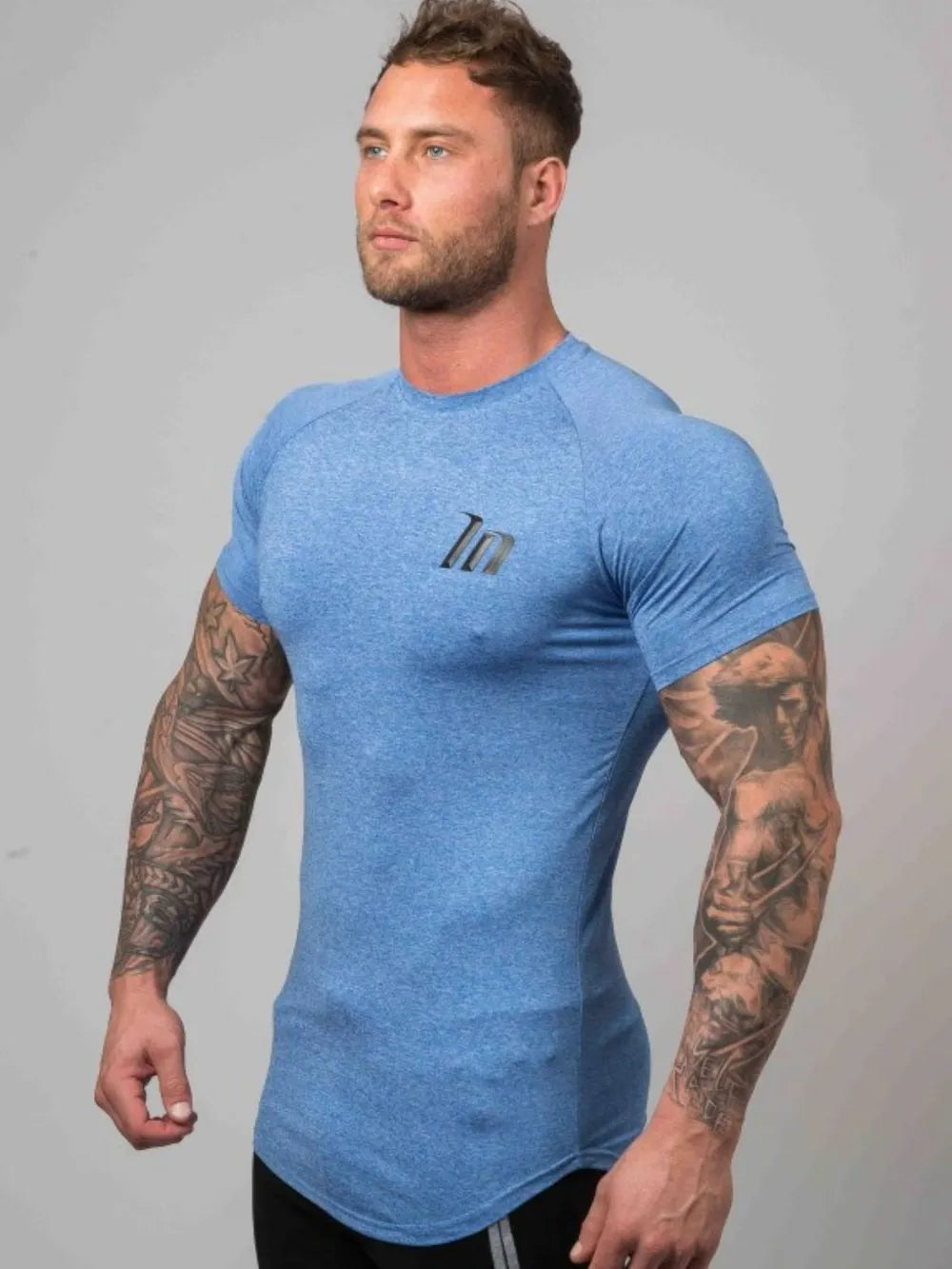 Sky blue performance fit raglan tee with black logo detail and short sleeves.