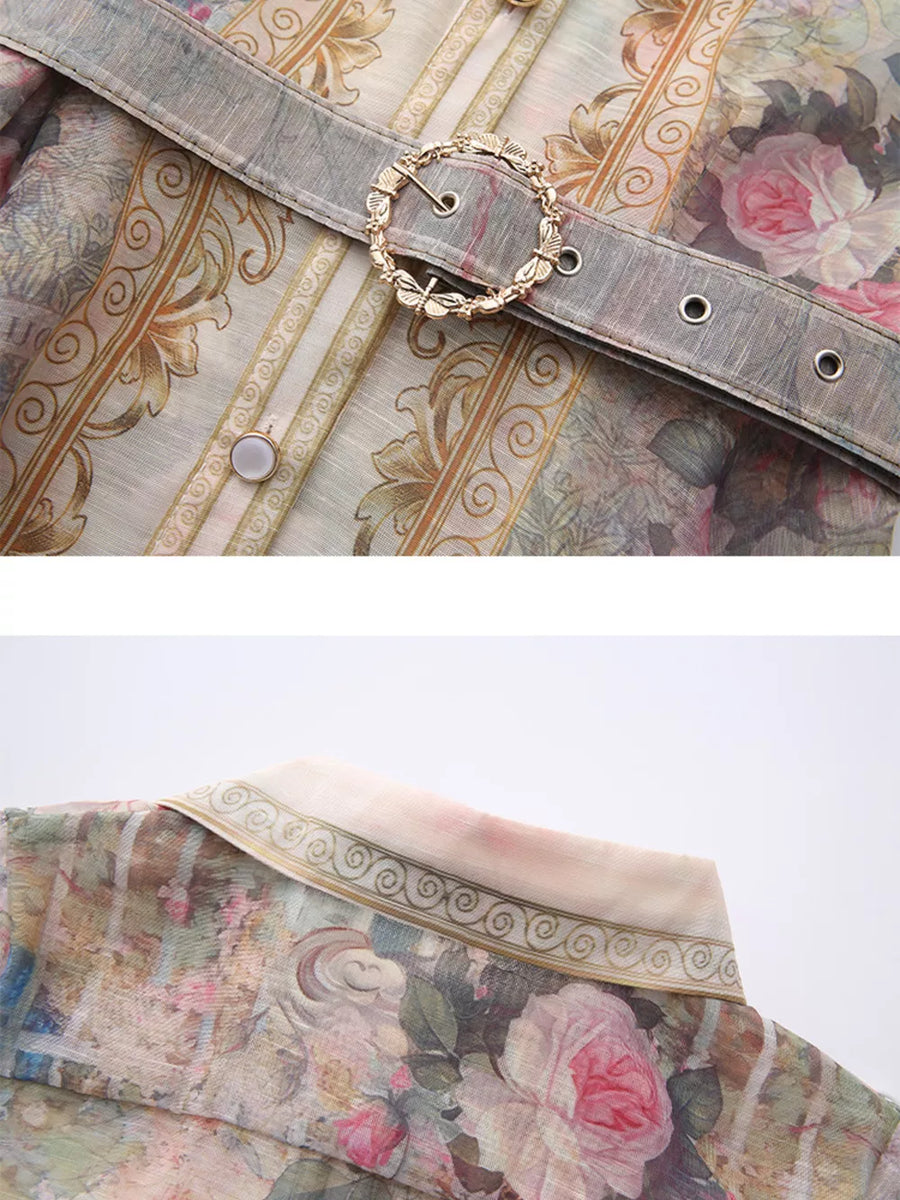Belted shirt dress with pastel floral print, ornate buckle detail, and button front.