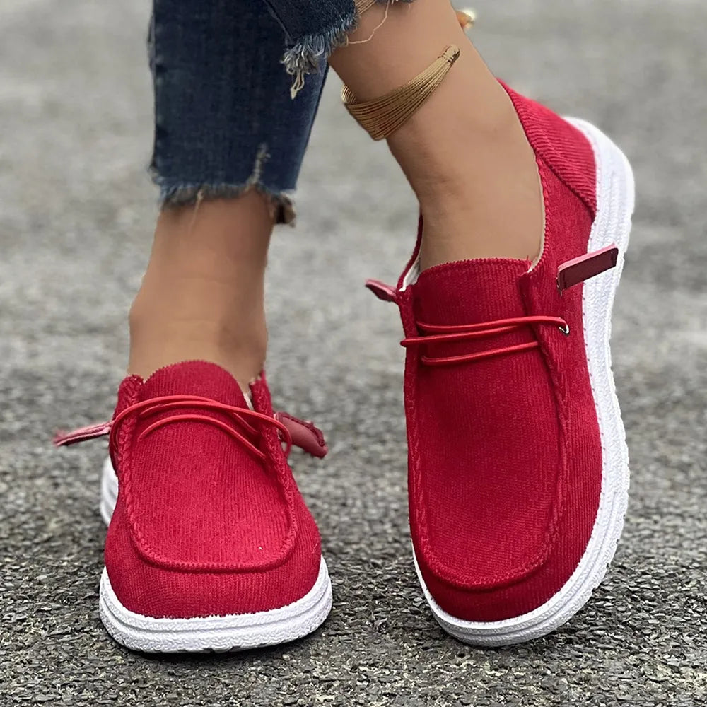 Red corduroy boat shoes with lace detail and white soles