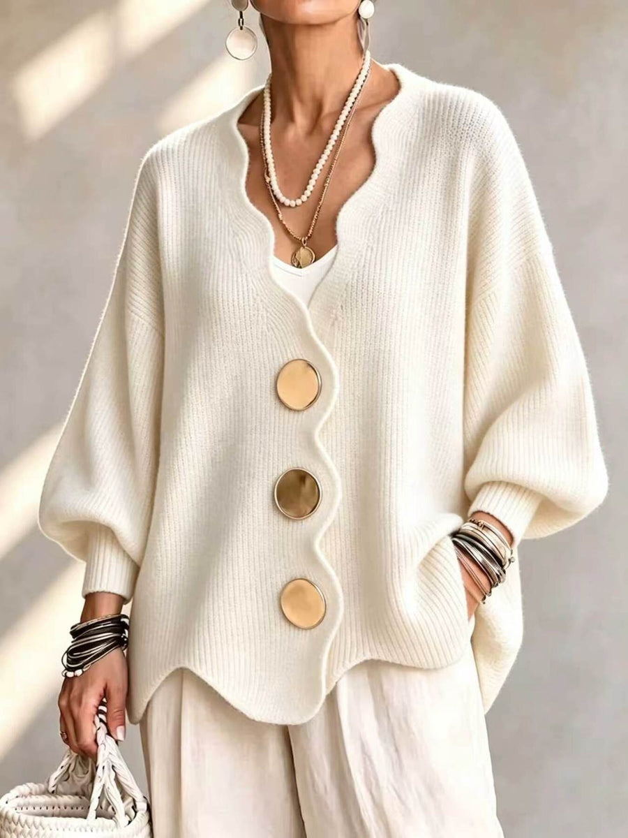 cardigan in cream featuring scalloped edge and oversized fit