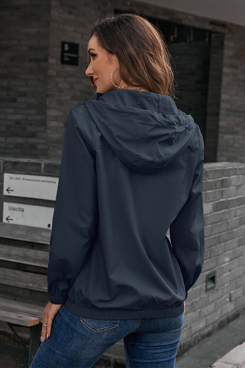 Dark blue hooded utility jacket with drawstring waist and elastic cuffs.