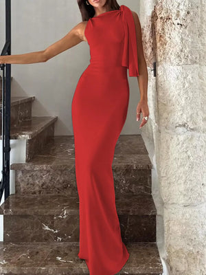 Red asymmetrical draped maxi dress with a bow detail on the shoulder.