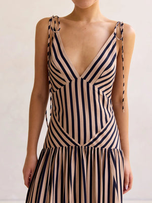 Tie-shoulder maxi dress with V-neck in navy and tan stripes, featuring adjustable tie straps and a tiered skirt.