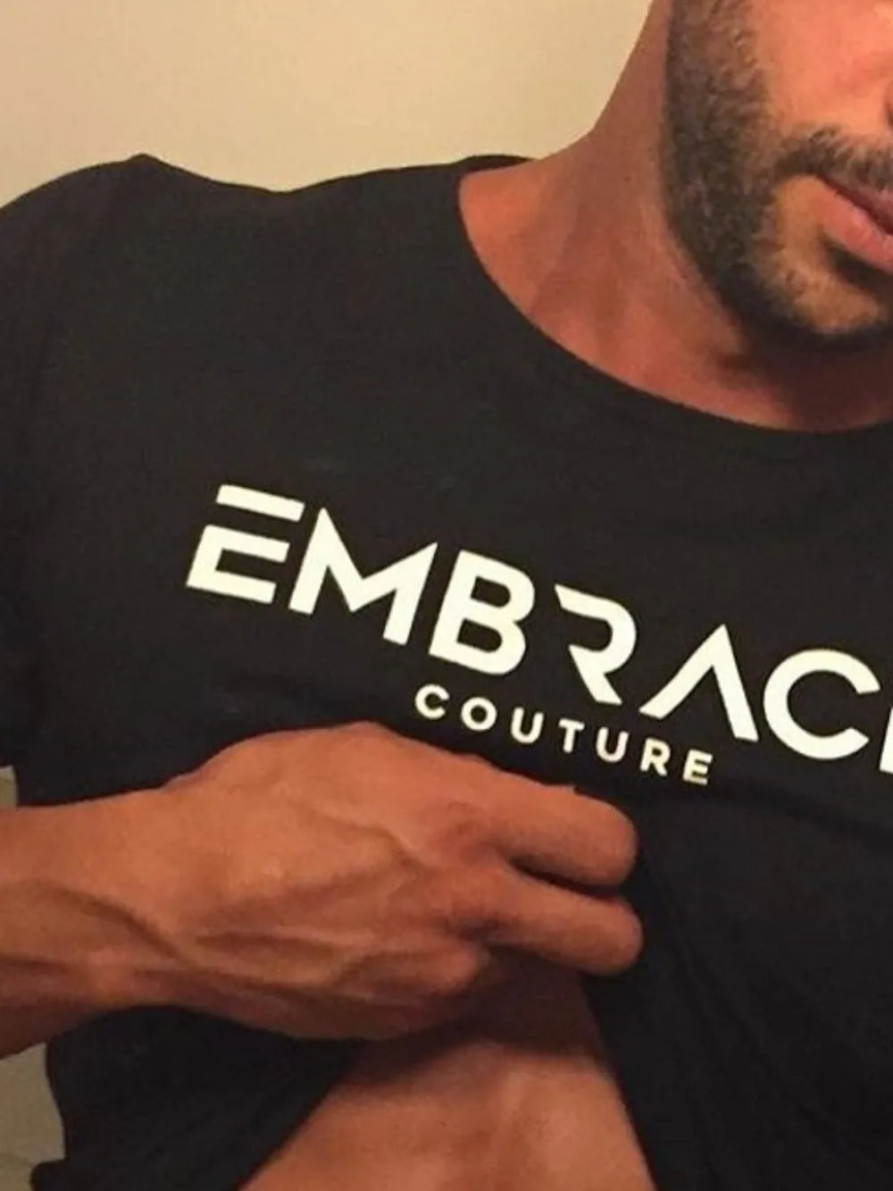 Black t-shirt with white Embrace Couture logo, crew neck, short sleeves.