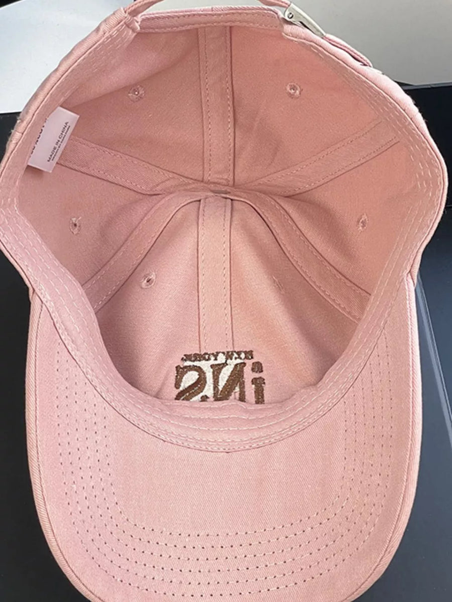 Pink baseball cap with embroidered logo and adjustable strap