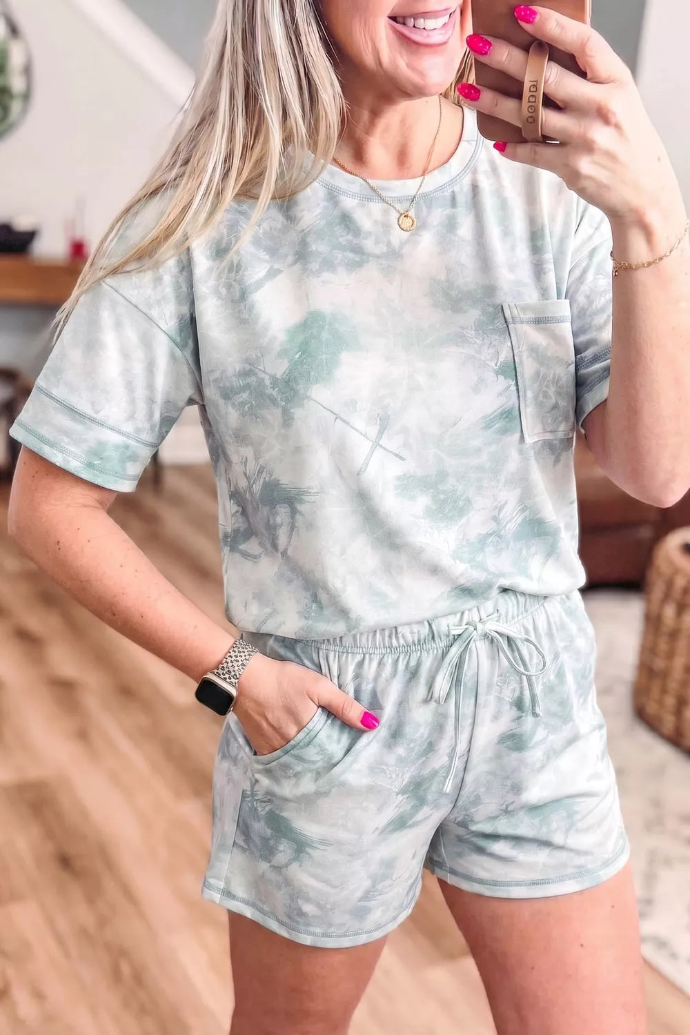 Tie dye lounge set with short sleeve tee and drawstring shorts.