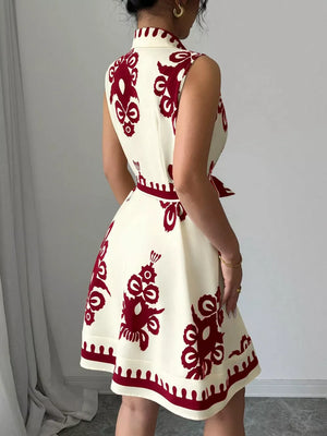 Cream sleeveless a-line dress with burgundy print and tie waist
