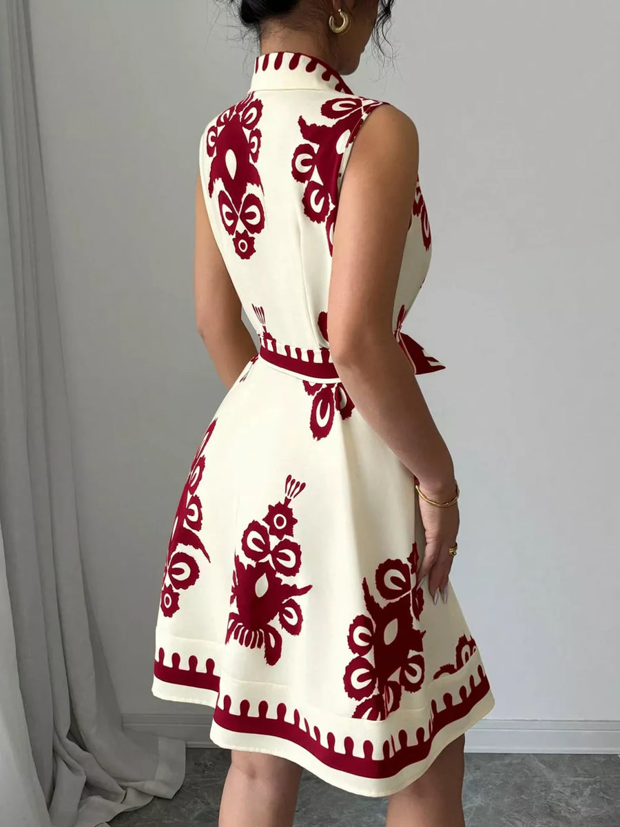 Cream sleeveless a-line dress with burgundy print and tie waist