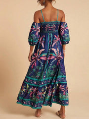 Maxi dress with smocked bodice, cold shoulder sleeves, and tropical palm print.
