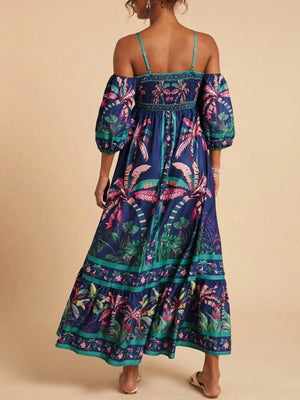 Maxi dress with smocked bodice, cold shoulder sleeves, and tropical palm print.