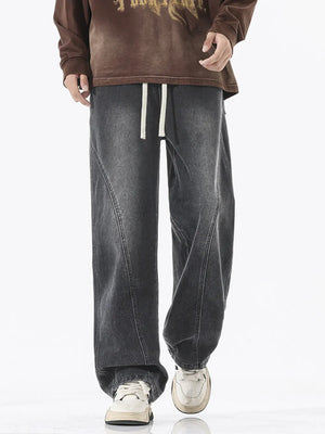 Relaxed fit wide-leg jeans in dark gray denim with drawstring waist and contrast stitching.