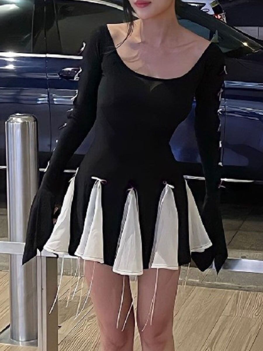 Black mini dress with scoop neck, long bell sleeves, and tiered white fabric skirt with bowknot details.