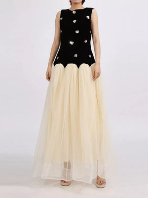 Black velvet sleeveless maxi dress with sequin floral detail and cream tulle skirt.