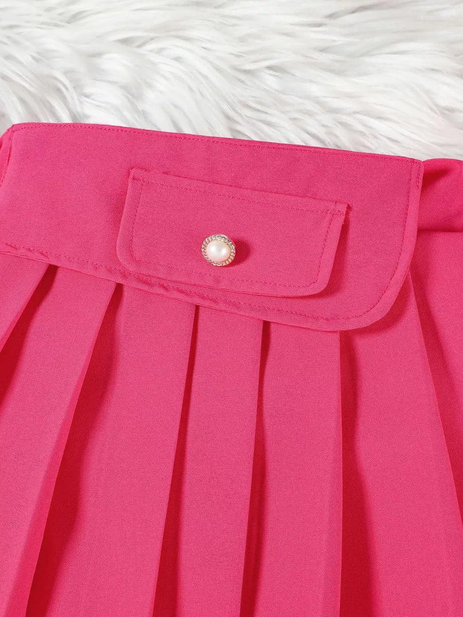 Pink baby skirt with pleated detail and decorative button on pocket.