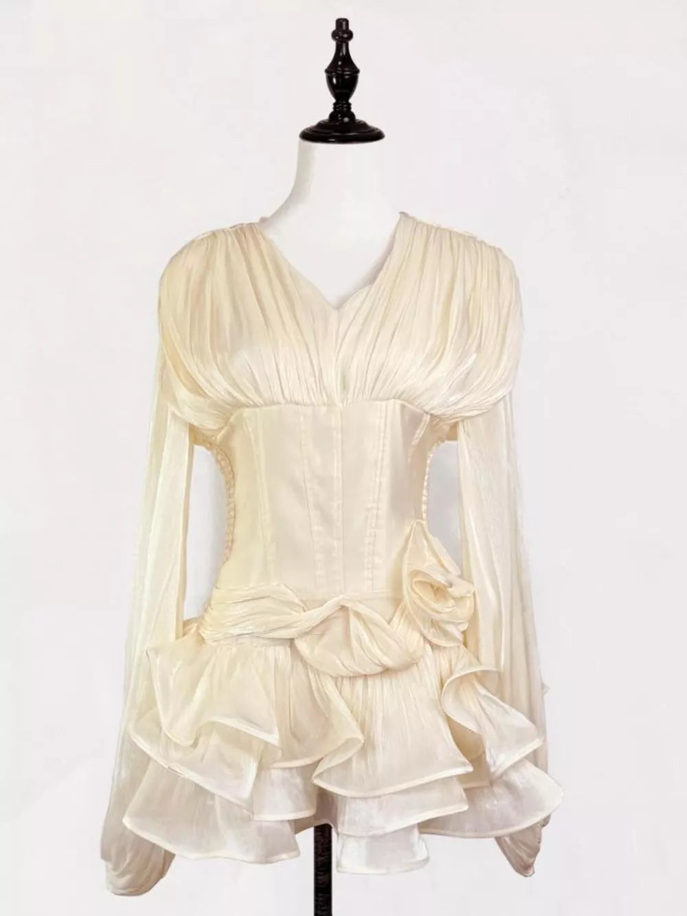 Elegant white ruffled mini dress with corset waist and long sheer sleeves.