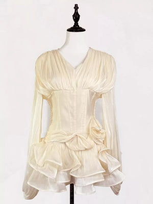 Elegant white ruffled mini dress with corset waist and long sheer sleeves.