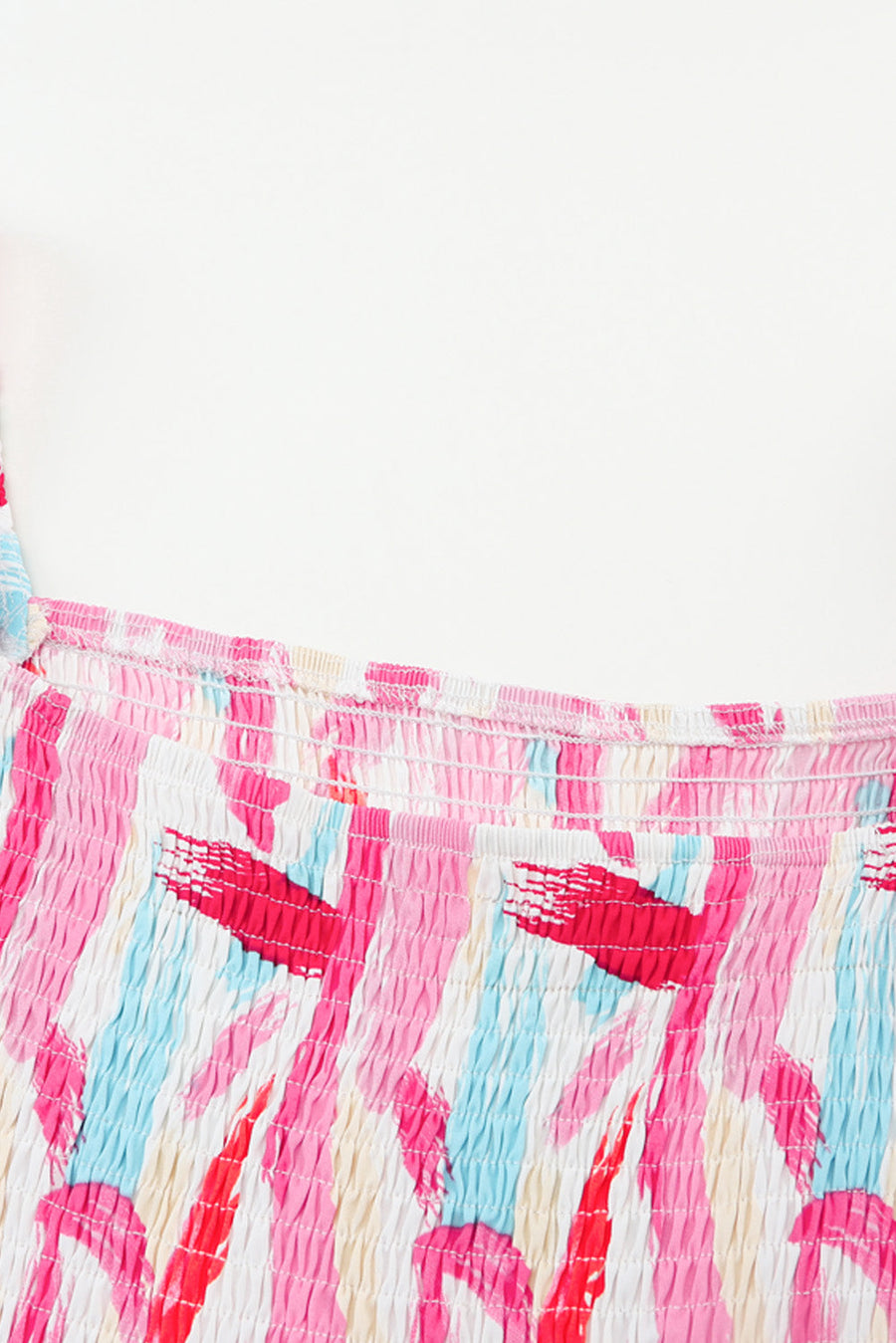 Smocked bodice midi dress in blush pink with abstract brushstroke print and balloon sleeves.