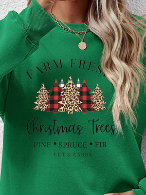 Green crewneck sweatshirt with Christmas trees graphic and text.
