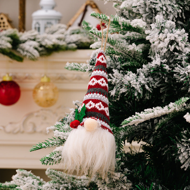 Christmas gnome ornament with red and gray striped hat and white beard.
