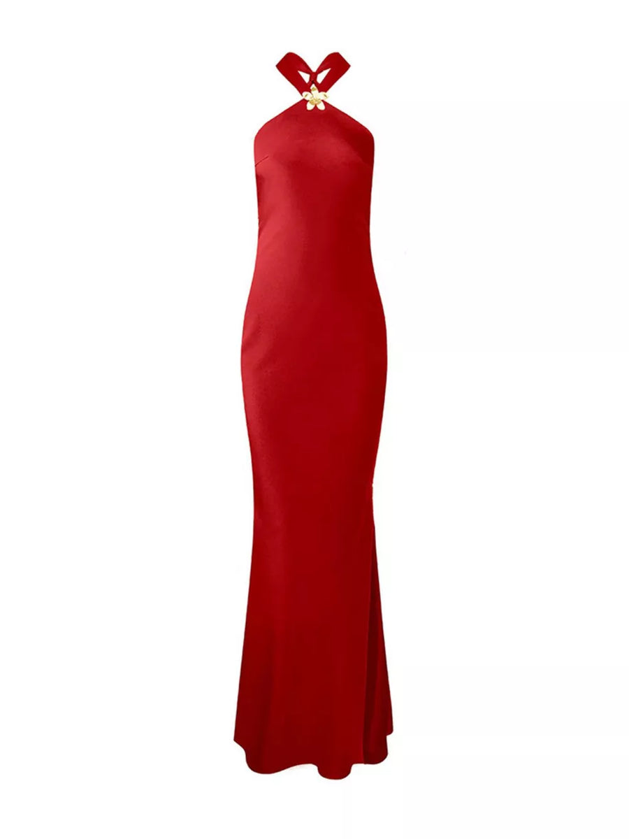 Red satin halter neck maxi dress with a gold flower detail at the neckline.