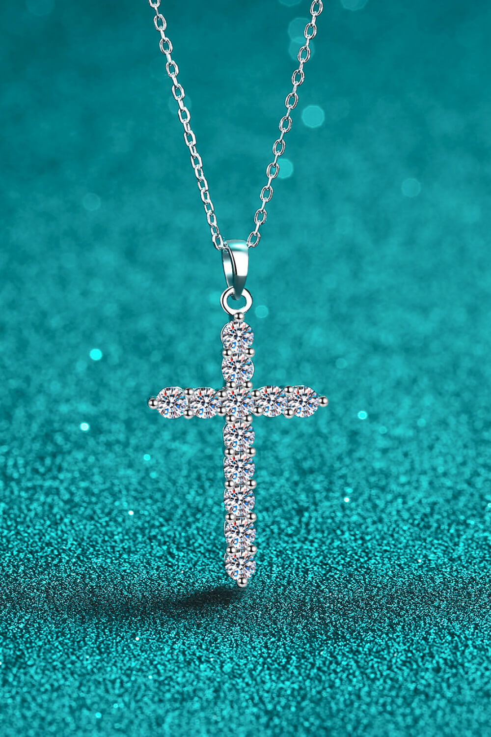 Silver pavé cross necklace with sparkling stones on a delicate chain.