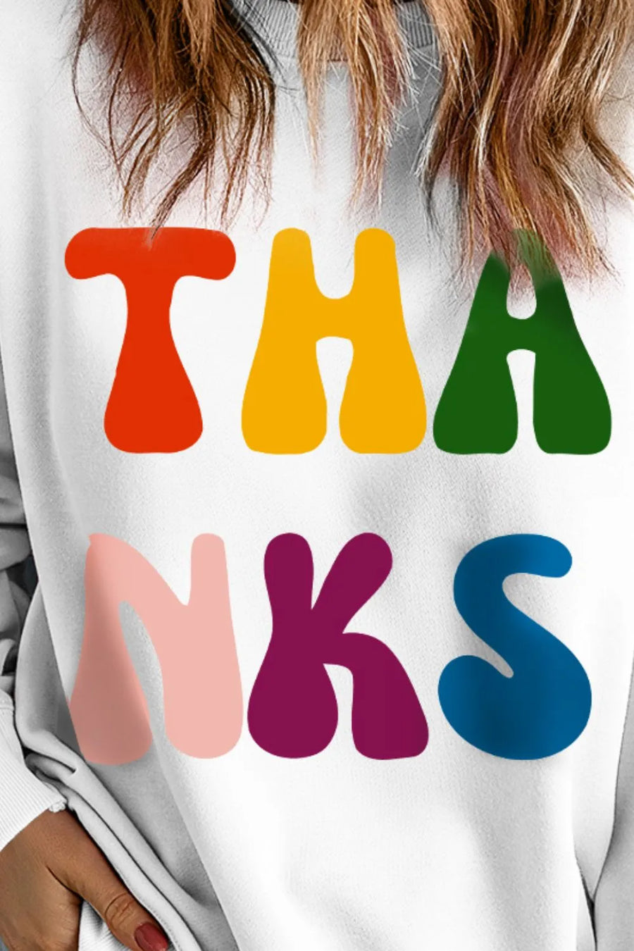 White graphic sweatshirt with colorful retro "THANKS" text, crewneck, long sleeves.