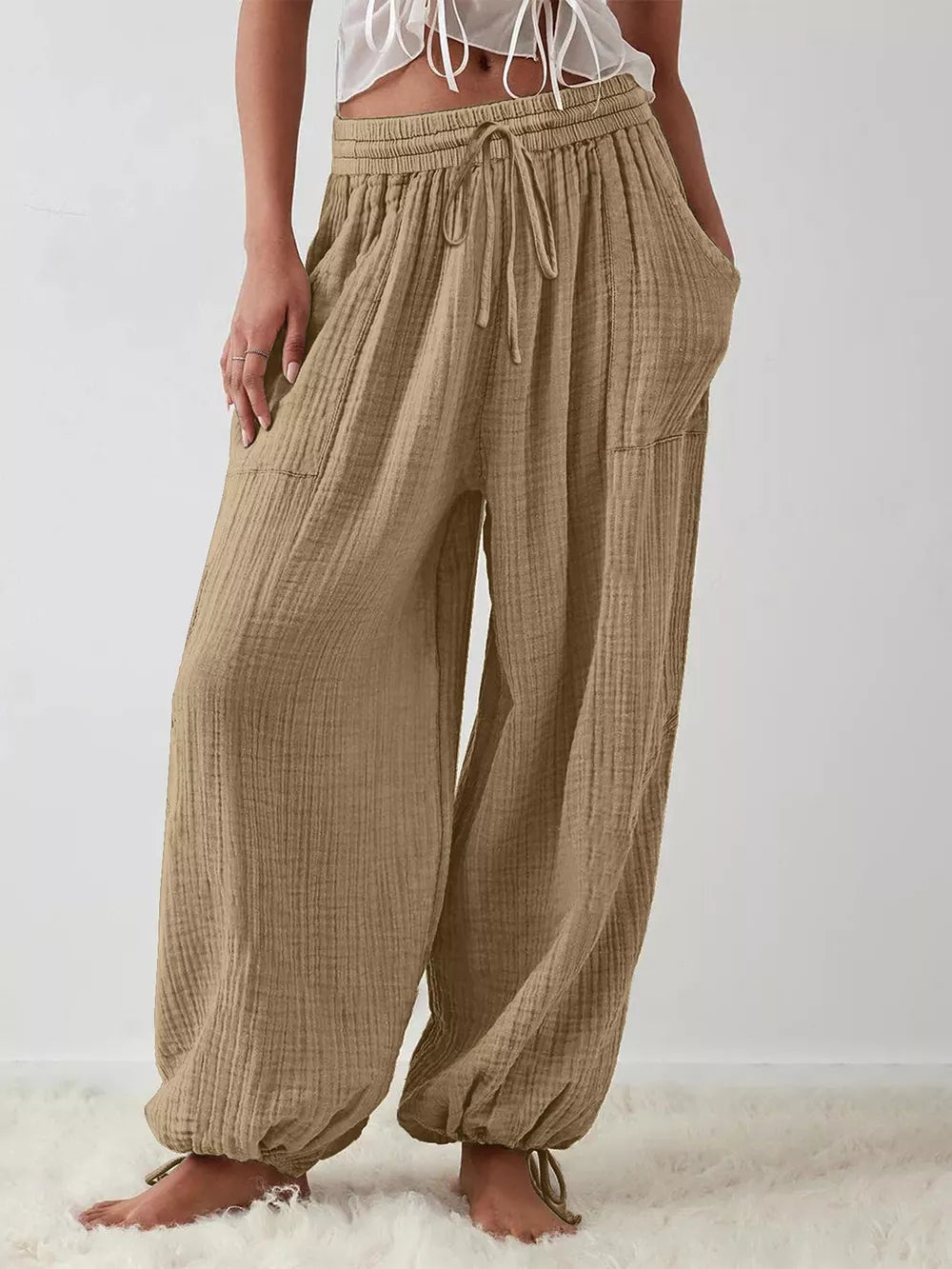 wide-leg pants in khaki featuring drawstring waist and loose fit