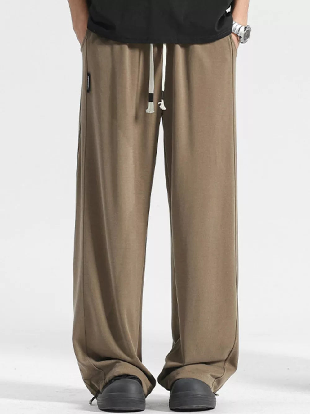 Men's light brown loose fit sweatpants with drawstring waist and cuffed ankles.