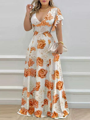 Maxi dress with floral print, V-neck, and ruffle sleeves in pumpkin orange.