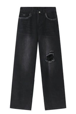 Distressed dark wide-leg jeans with raw hem and ripped knee detail