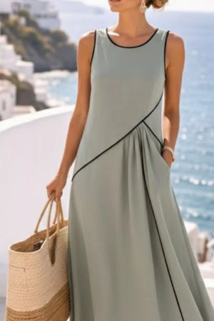 Sage maxi dress with black contrast piping and a draped front.