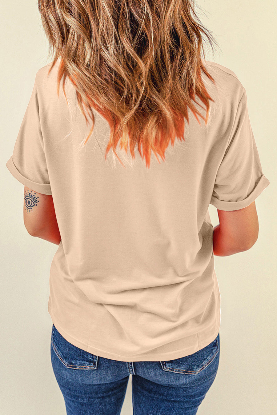 Eggshell t-shirt with rolled sleeves and a graphic detail on the left sleeve.