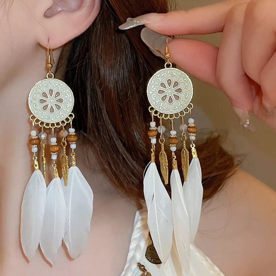 white earrings featuring feather accents and floral
