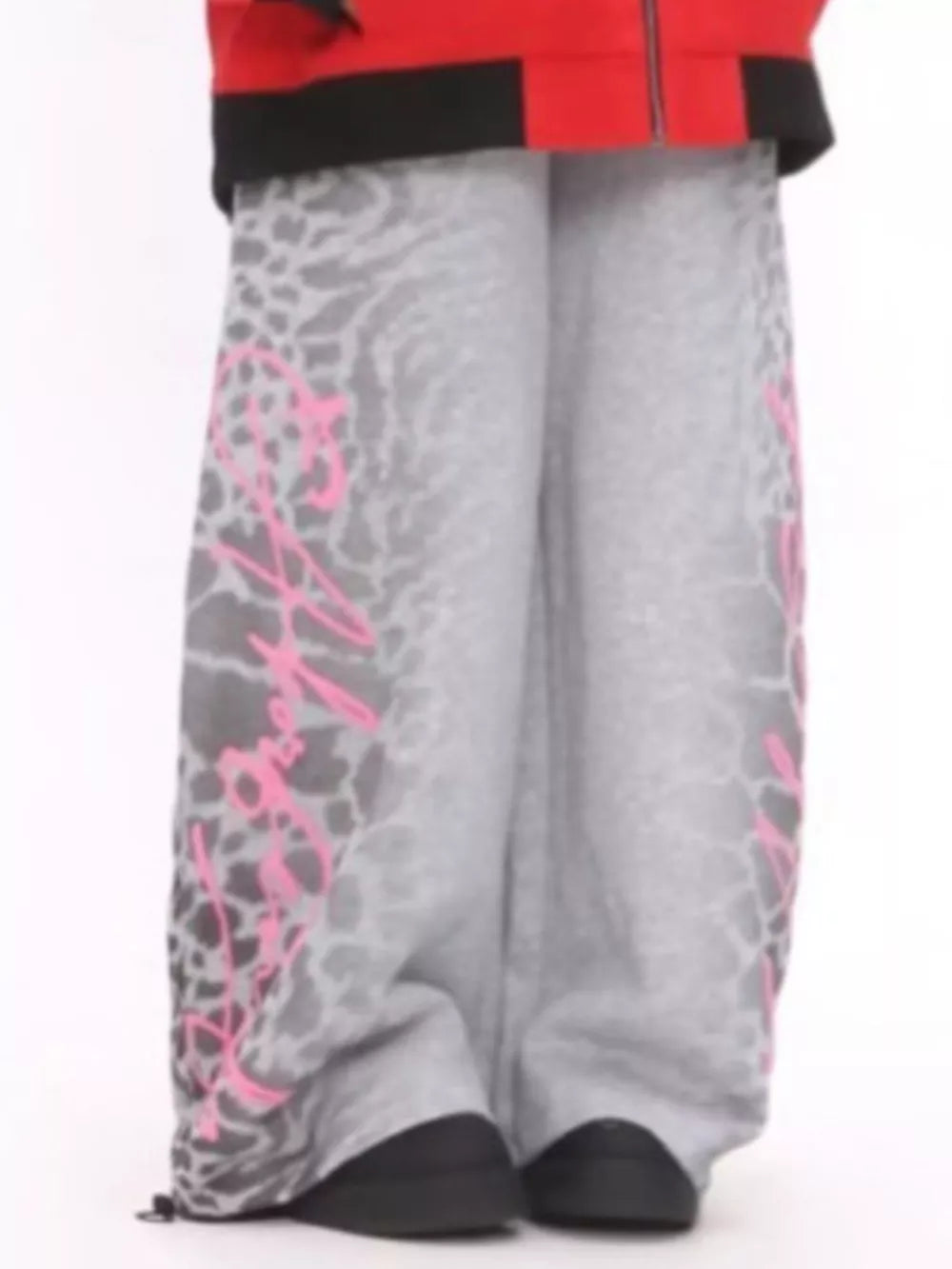 Men's grey cotton sweatpants with leopard print and pink graphic detail, wide leg.