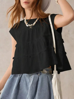 Black tiered ruffle blouse with short sleeves and textured fabric.