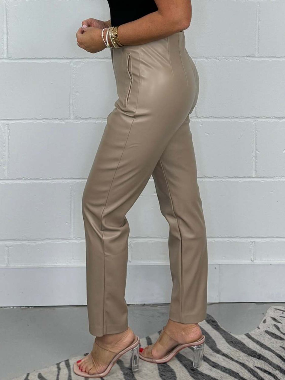 Mocha faux leather tailored trousers with a straight leg and pocket detail.
