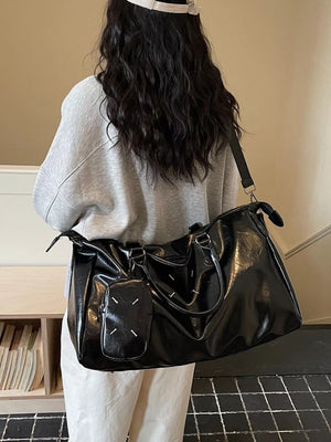 Sleek black metallic large travel bag with adjustable strap and detachable pouch.