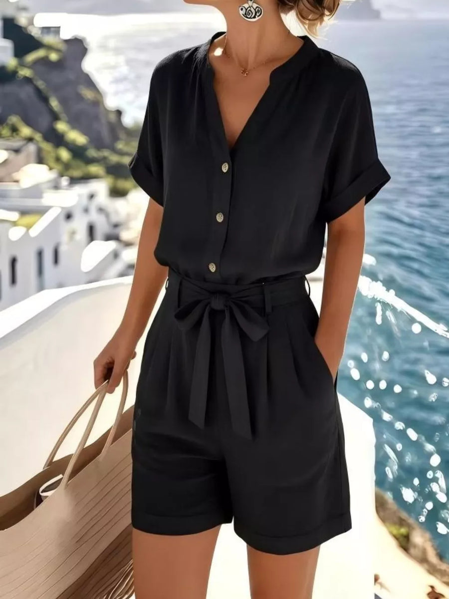 Black button-down shirt with cuffed sleeves and belted paperbag shorts set.