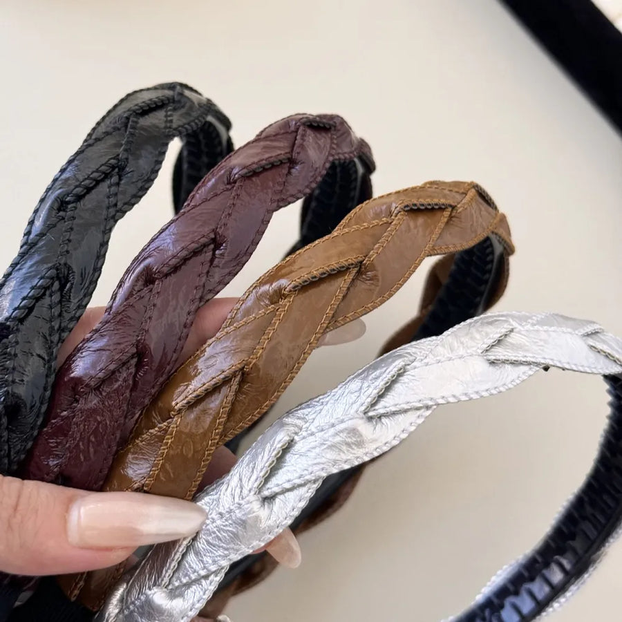Woven faux leather headbands in burgundy, camel, black, and silver with braided detail.
