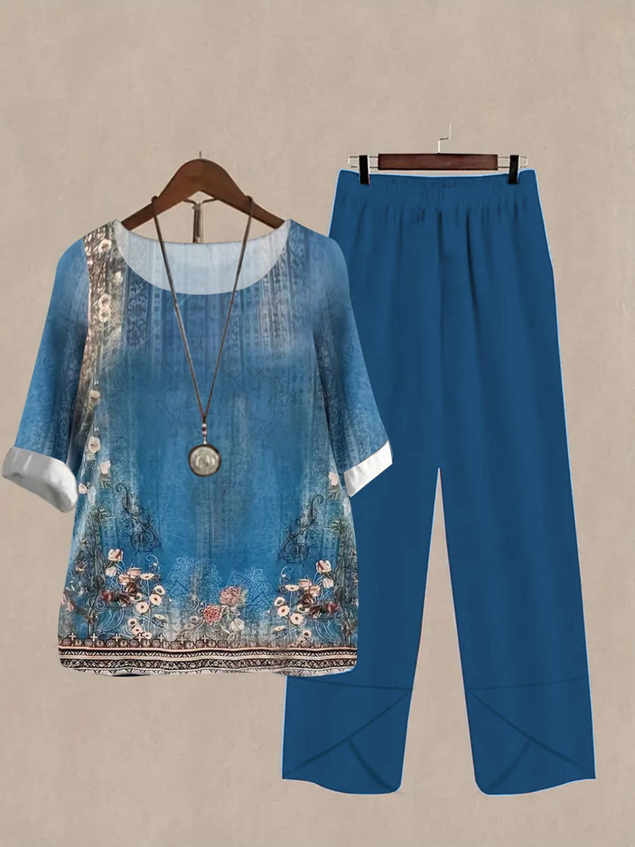 Floral print half sleeve top and blue pants set with round neck and white cuffs.