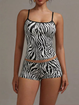 Women's zebra print cami and shorts pajama set with black trim.
