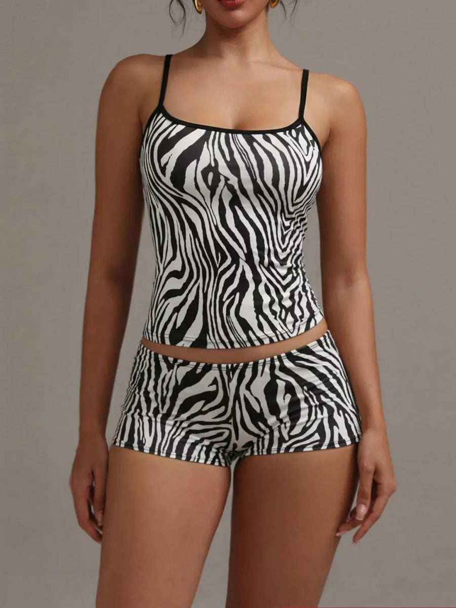 Women's zebra print cami and shorts pajama set with black trim.