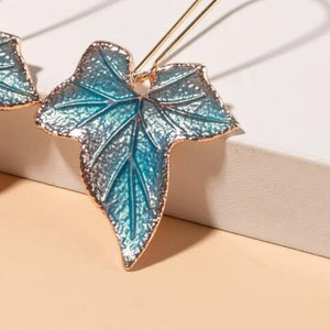Sky blue enamel ivy leaf drop earrings with gold trim.