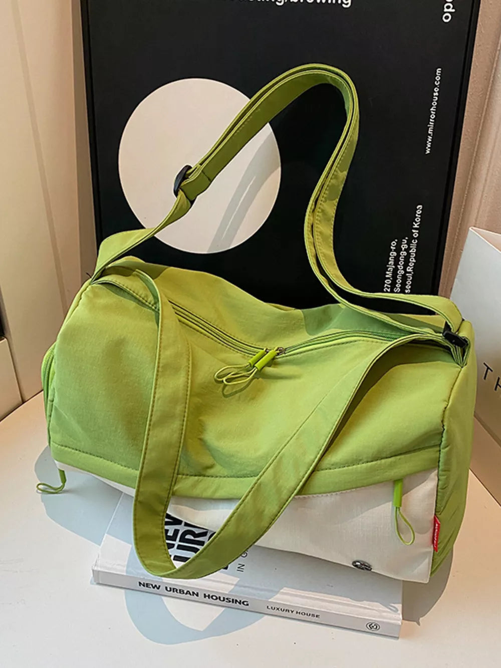 Vibrant color-block nylon travel bag with green and white panels and a crossbody strap.