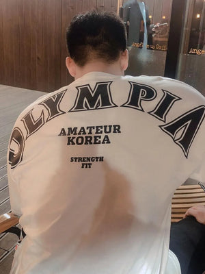 White oversized tee with black Olympia graphic and text print on back